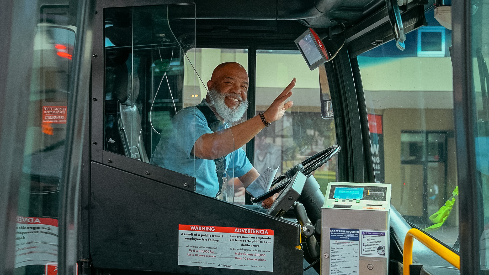 bus operator smiling and waving