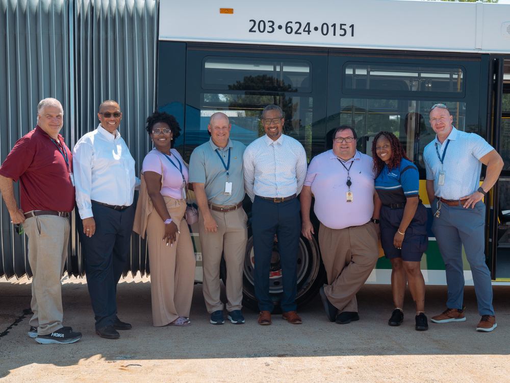 Team in front of a bus